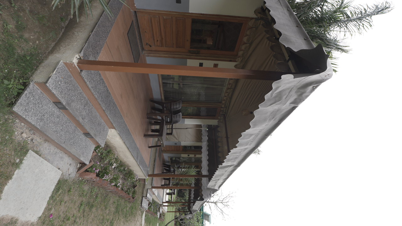 Pinewood cottages and their covered verandas at Maldevta Farms